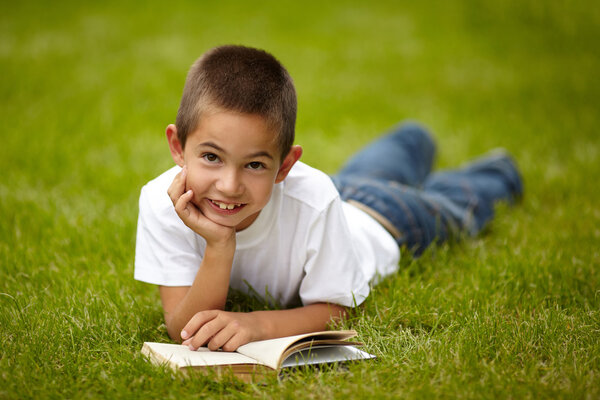 little happy boy reading book