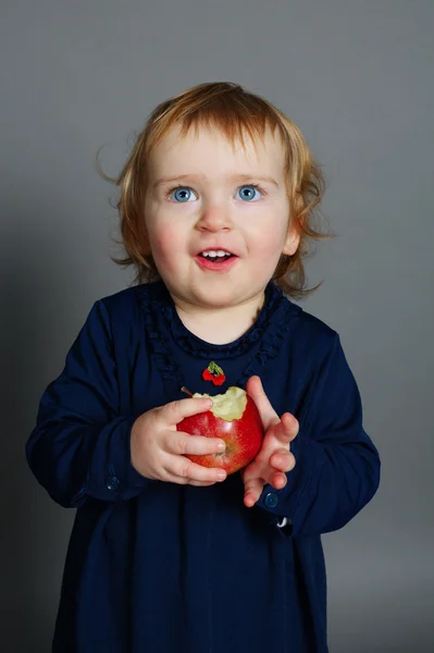 Little girl eating an apple — Stock Photo, Image