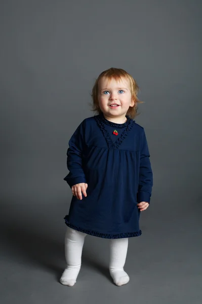 Cute little girl on dark background — Stock Photo, Image