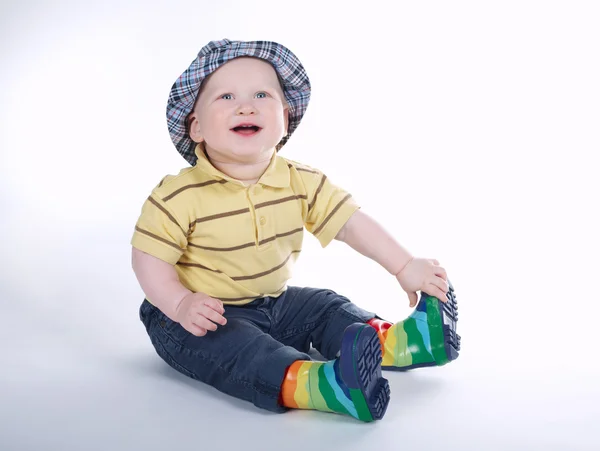 Engraçado menino em gumboots isolado no branco — Fotografia de Stock