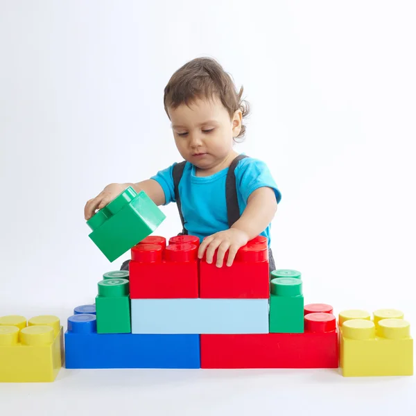 Little boy plays with colorful cubes — Stock Photo, Image