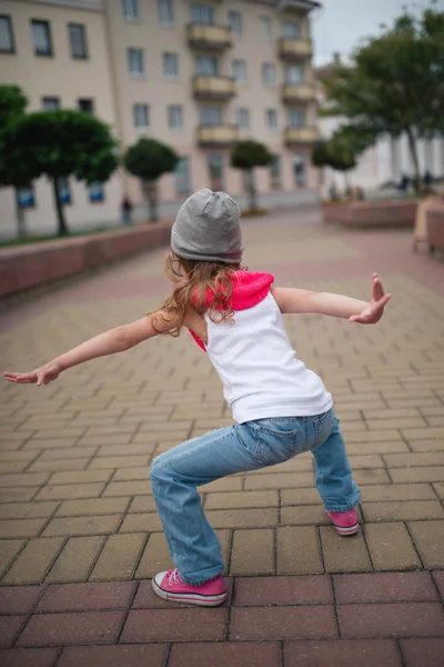 Little girl dancing on the street — Stock Photo, Image