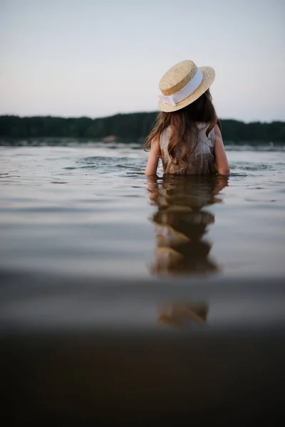 Pequeña linda chica con el pelo largo en el lago —  Fotos de Stock