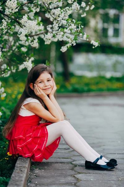 Niña cerca de flores de manzano en el parque —  Fotos de Stock