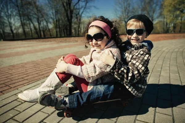 男の子と女の子が通りの上でスケート — ストック写真