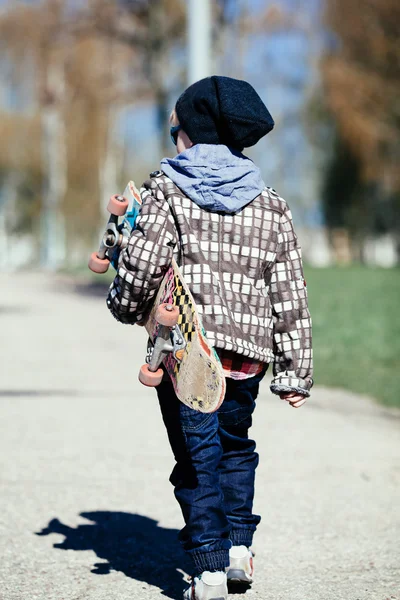 Little boy with skateboard on the street — Stock Photo, Image