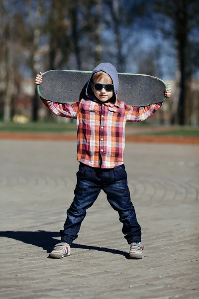 Little boy with skateboard on the street — Stock Photo, Image