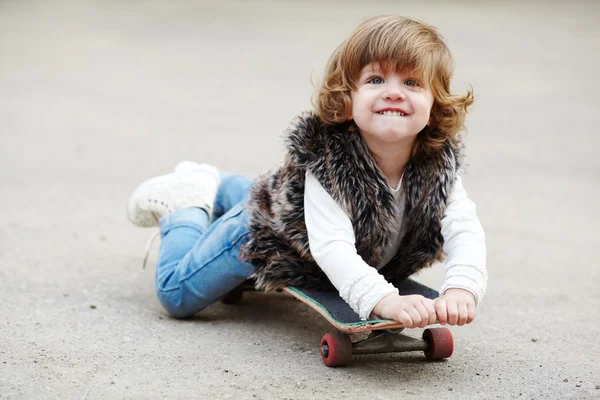 Little hipster girl with skateboard portrait — Stock Photo, Image