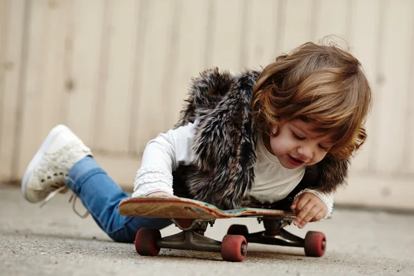 Little hipster girl with skateboard portrait — Stock Photo, Image