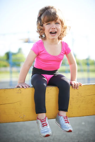 Unhappy girl crying on the playground — Stock Photo, Image