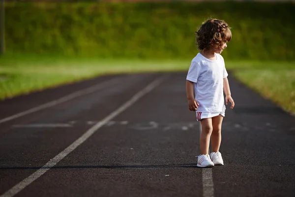 Cute girl running at stadium photo — Stock Photo, Image