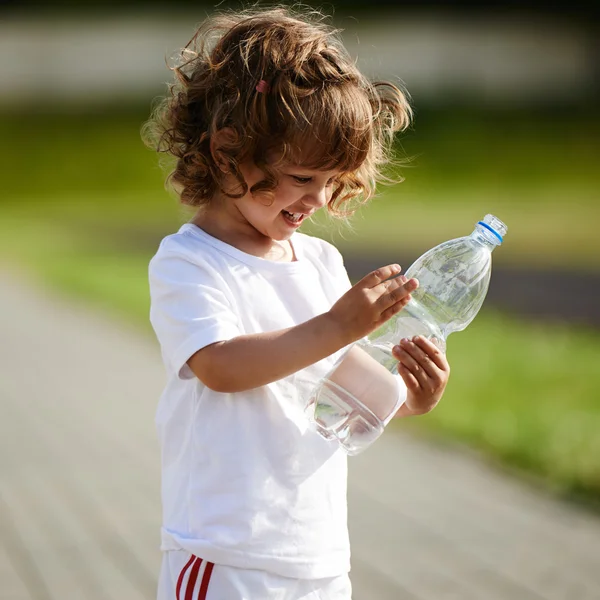 어린 소녀가 병에서 깨끗 한 물을 마 시 — 스톡 사진