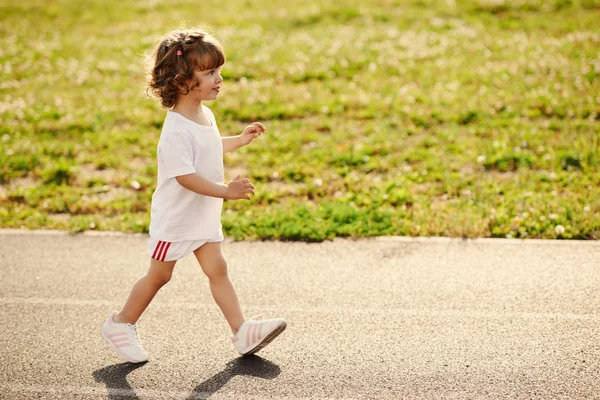 Cute girl running at stadium photo — Stock Photo, Image