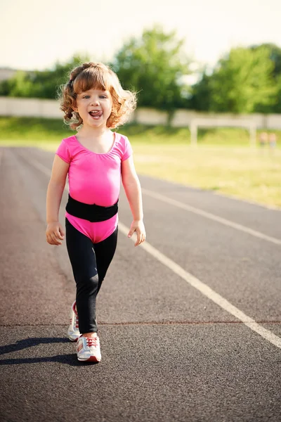 Ittle cute girl running at stadium — Stock Photo, Image