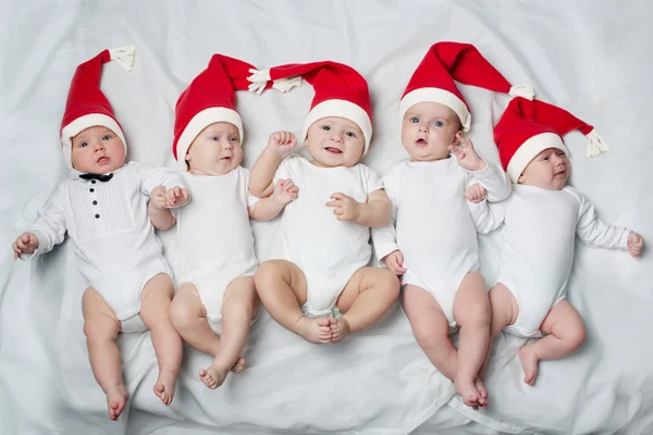 Cute babies with santa hats — Stock Photo, Image