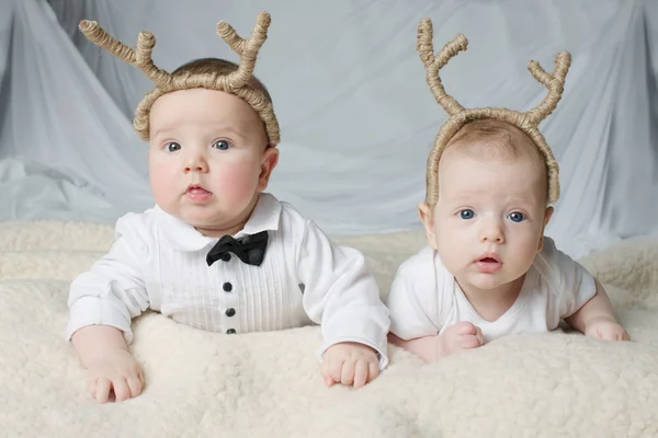 Cute babies with deer horns — Stock Photo, Image