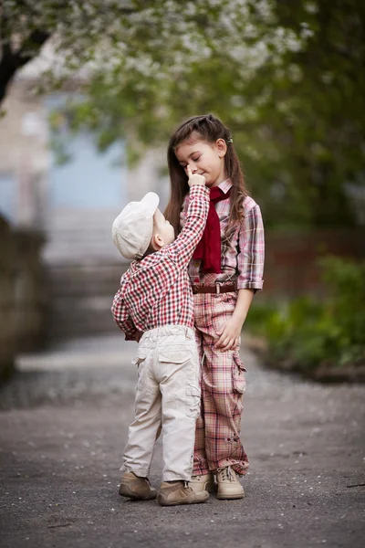 Boy hugging cute sister and looks up — Stock Photo, Image