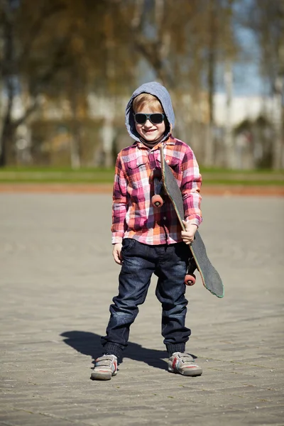 Little boy with skateboard on the street — Stock Photo, Image