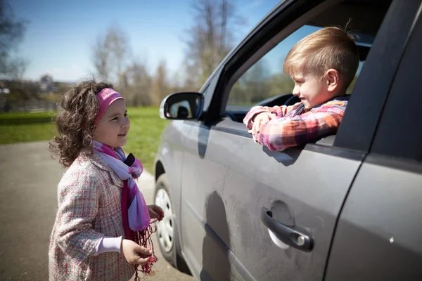 Girl and boy driving fathers car — Stock Photo, Image