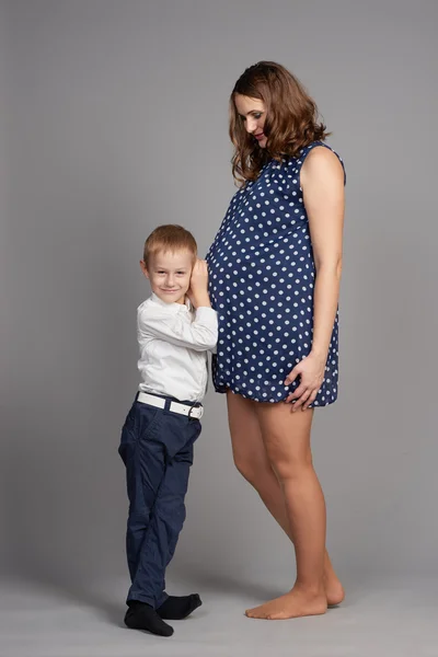 Young boy hug pregnant mother — Stock Photo, Image