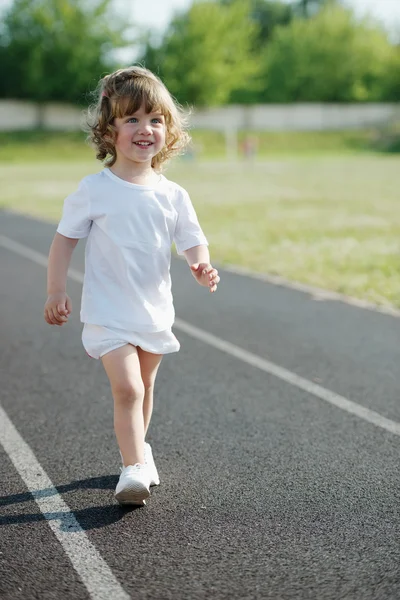 Cute girl running at stadium photo — Stock Photo, Image