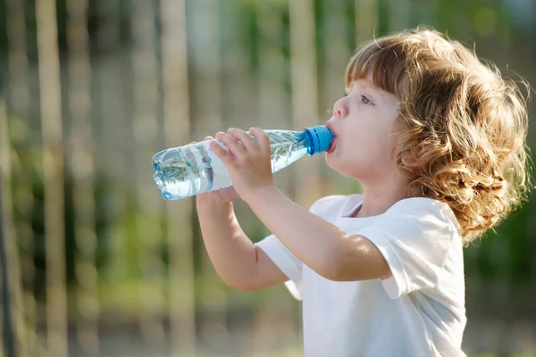 Küçük kız temiz su plastik Şişeden içme — Stok fotoğraf