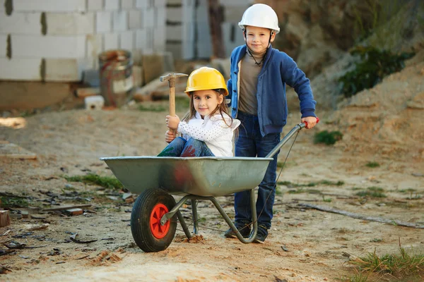 Menino e menina jogando no local de construção — Fotografia de Stock