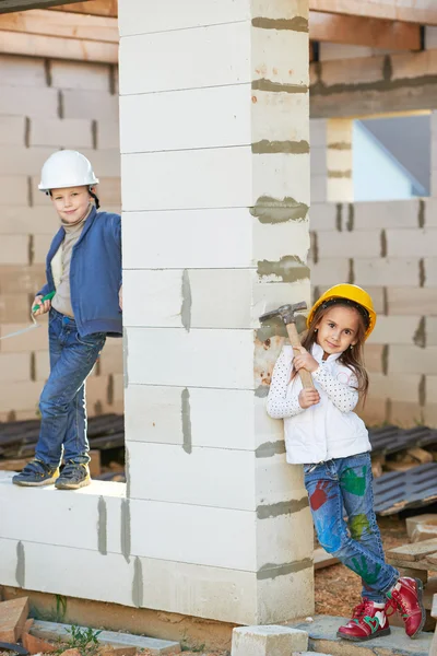 Niño y niña jugando en el sitio de construcción — Foto de Stock