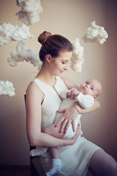 Mother with baby on white clouds — Stock Photo, Image