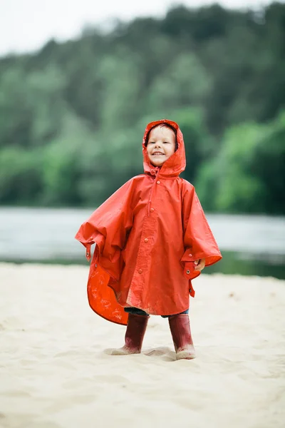 Little funny girl with raincoat — Stock Photo, Image