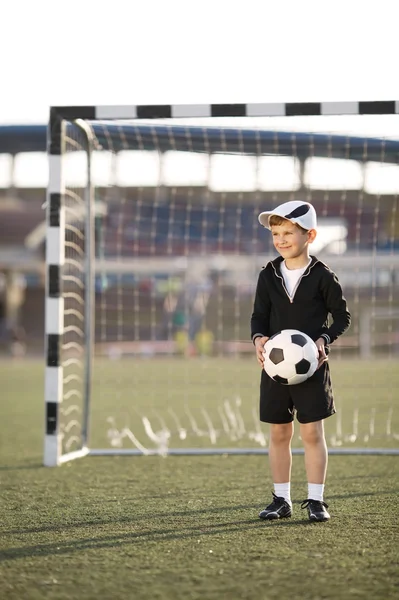 Anak laki-laki bermain sepak bola di stadion — Stok Foto