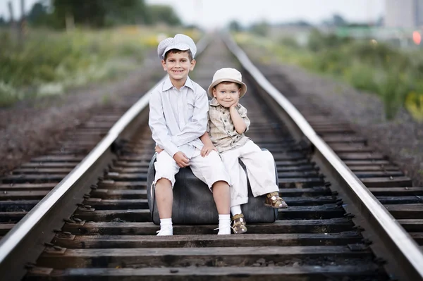 Dos chicos con maleta en los ferrocarriles —  Fotos de Stock