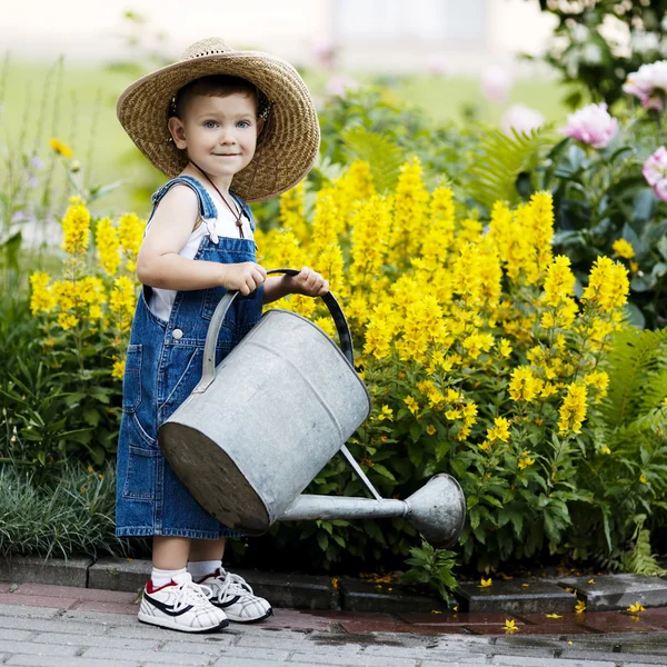 Little boy with watering can in summer park — Stock Photo, Image