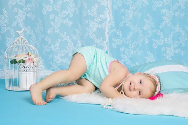 Girl lying on floor studio portrait — Stock Photo, Image