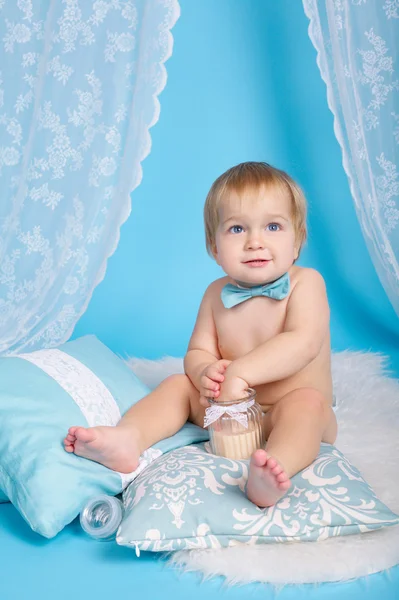 Boy plays with pillows studio portrait — Stock Photo, Image