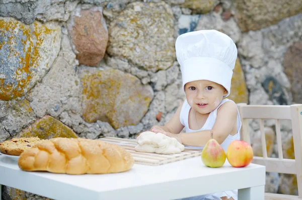 Kleine jongen met chef-kok hoed koken — Stockfoto