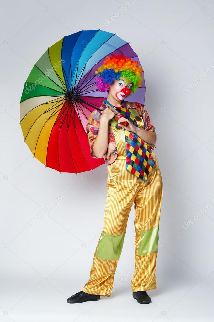 clown with colorful umbrella on white