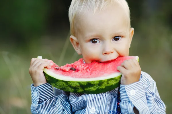 stock image little boy eats watermelon