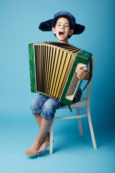 Little accordion player on blue background — Stock Photo, Image