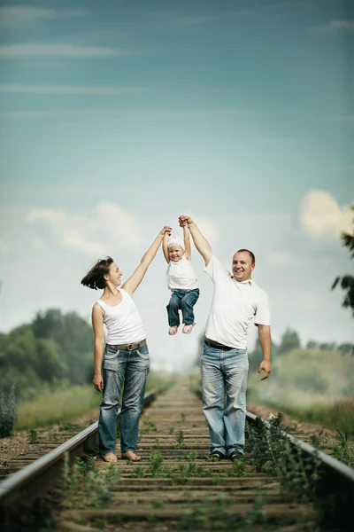 Pais com bebê na estrada de ferro — Fotografia de Stock