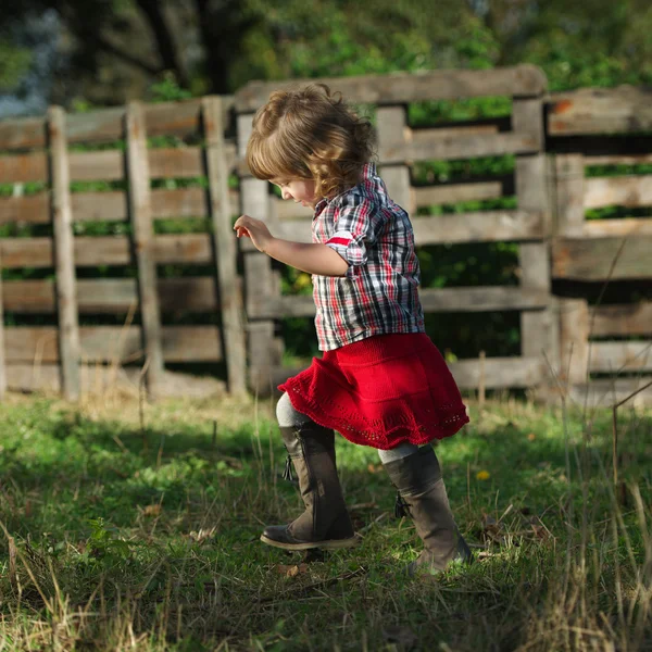 Schattig klein meisje wandelingen in het dorp — Stockfoto