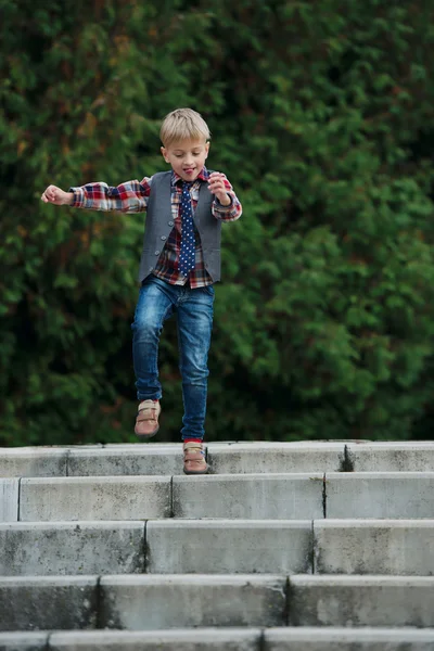Little boy jumping on the stairs — Stock Photo, Image