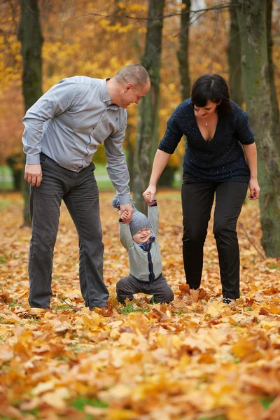 Happy family in autumn park — Stock Photo, Image