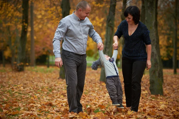 Happy family in autumn park — Stock Photo, Image