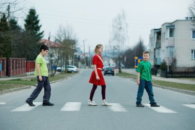 children crossing street on crosswalk