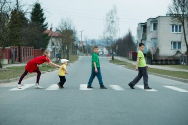 children crossing street on crosswalk