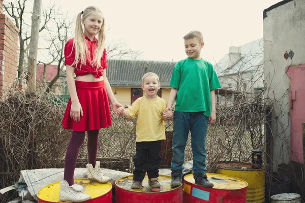 Children play at dump drums — Stock Photo, Image