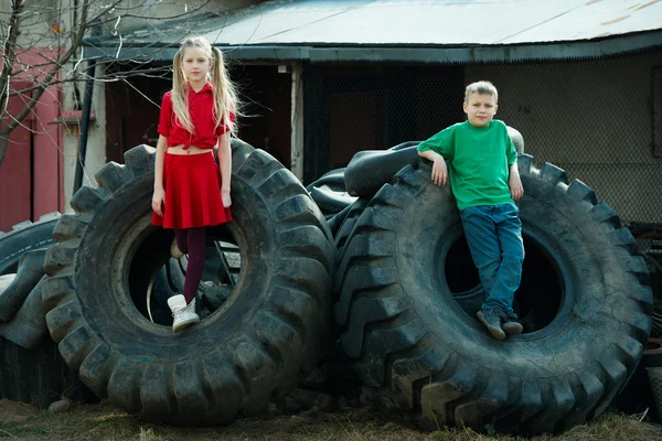 Kinderen spelen in autokerkhof banden — Stockfoto