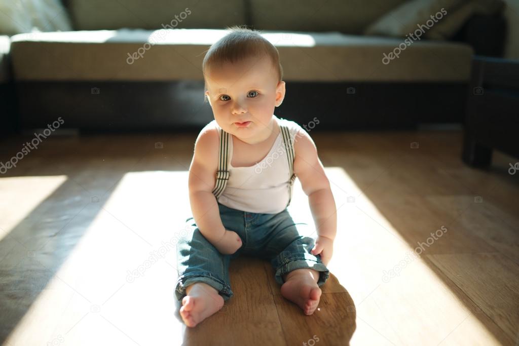 cute little boy sitting on the floor