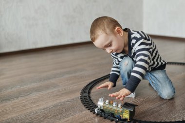 küçük çocuk oyuncak demiryolu oluşturur